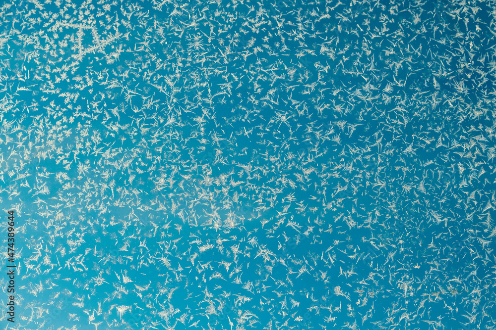 Abstract background with snowflakes on a window
