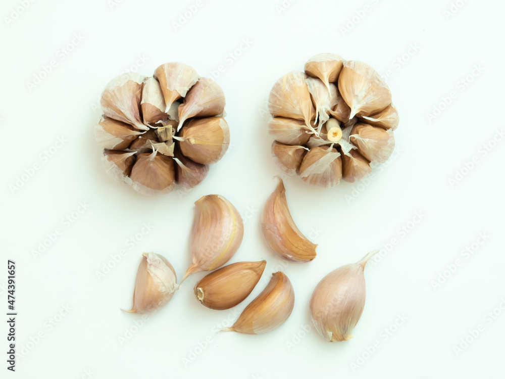 Peeled whole garlic in cloves isolated on white background with negative space
