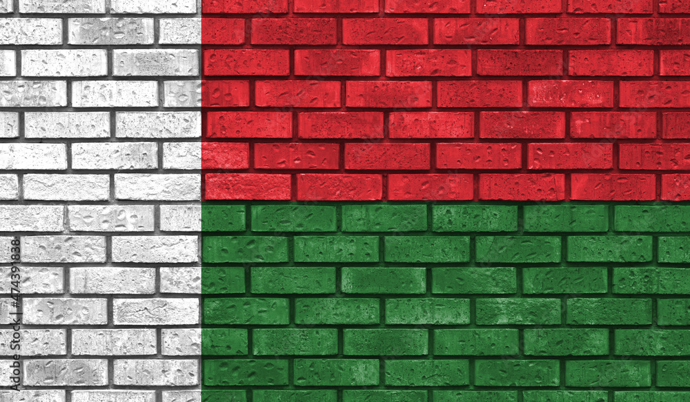 Madagascar flag on a brick wall Madagascar flag on a brick wall