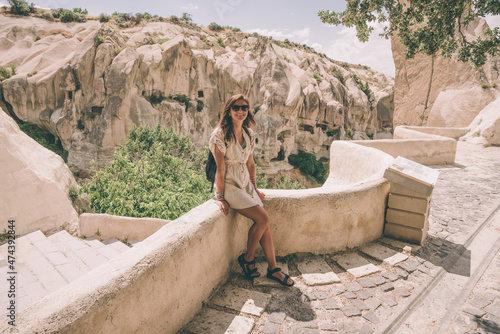 girl in Zelve Open Air Museum. Unique geological formations in Zelve valley, Cappadocia, Central Anatolia, Turkey photo