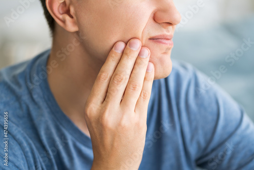 A man with toothache, periodontal disease in wisdom teeth photo