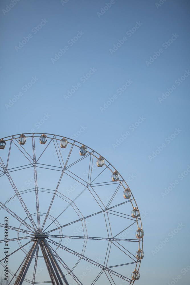 Ferris wheel in winter against the blue sky.