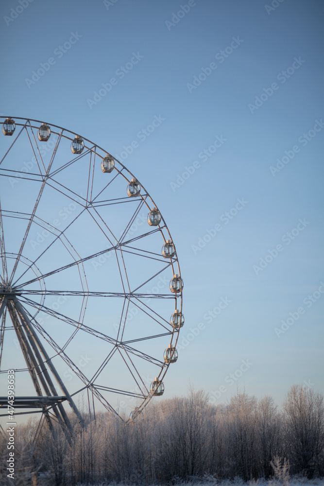 Fototapeta premium Ferris wheel in winter against the blue sky.