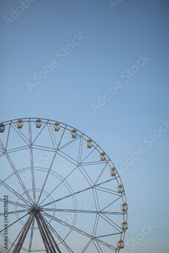 Ferris wheel in winter against the blue sky.
