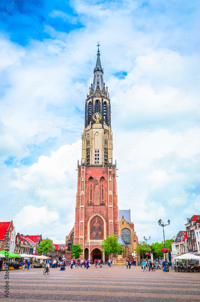 Fototapeta premium Nieuwe Kerk tower and traditional houses on Market square of old beautiful city Delft, Netherlands