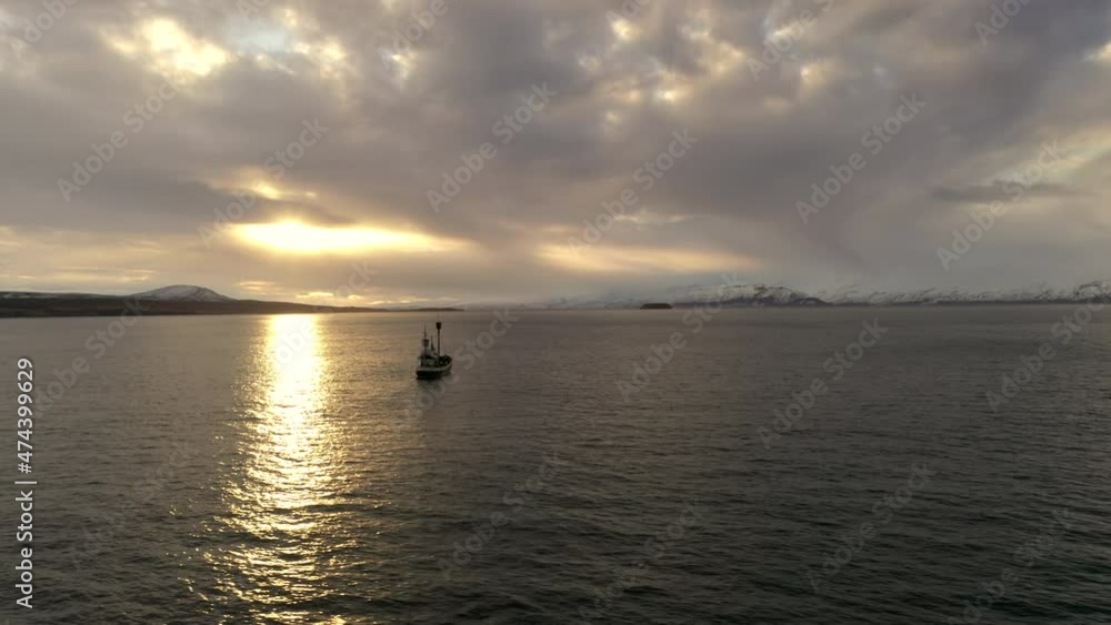 Aerial view of boat in Iceland. Snowy mountains in the background. Aerial view of boat in Iceland. Snowy mountains in the background.