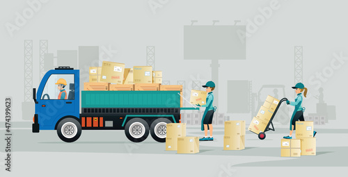 Workers are loading boxes onto a truck with a gray background.