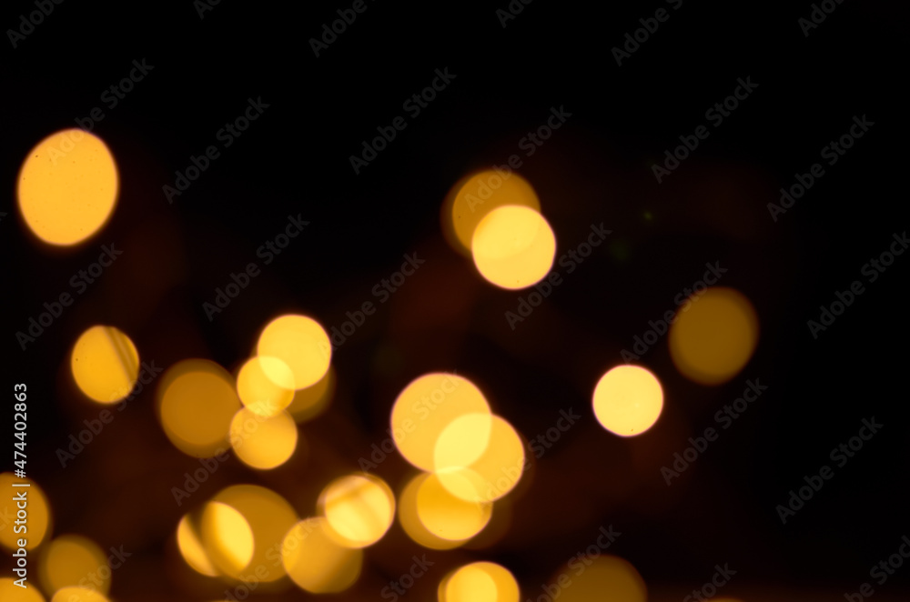 Fototapeta premium golden defocused lights on a black background