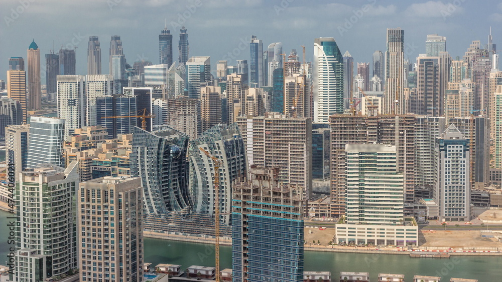 Naklejka premium Skyline with modern architecture of Dubai business bay towers timelapse. Aerial view