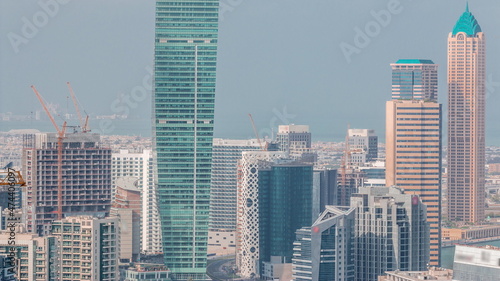 Skyline with modern architecture of Dubai business bay towers timelapse. Aerial view