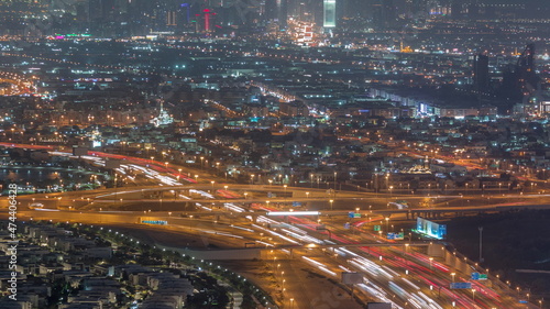 Top view city traffic on a big crossroad in Business bay night timelapse. © neiezhmakov