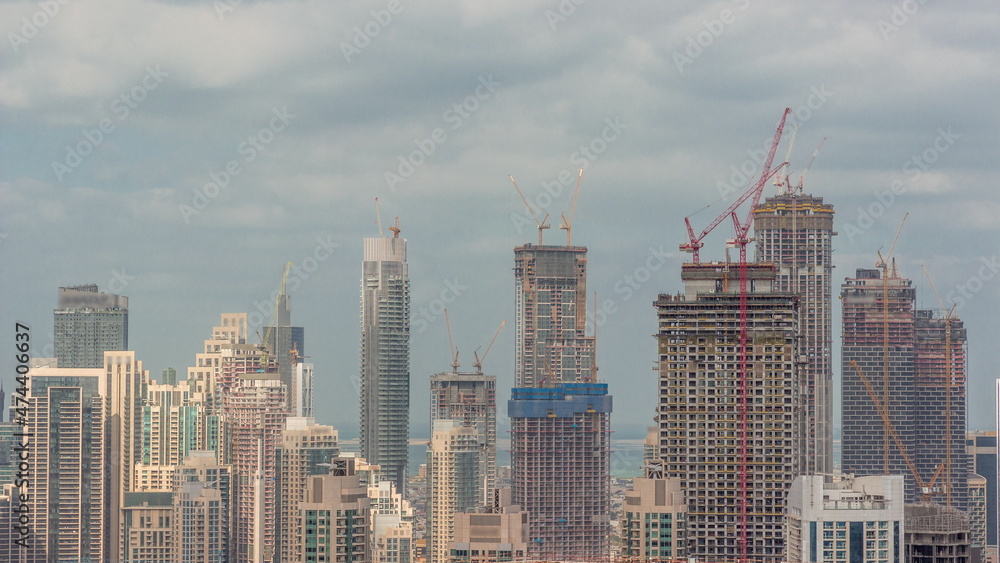High multi-storey buildings under construction and cranes timelapse
