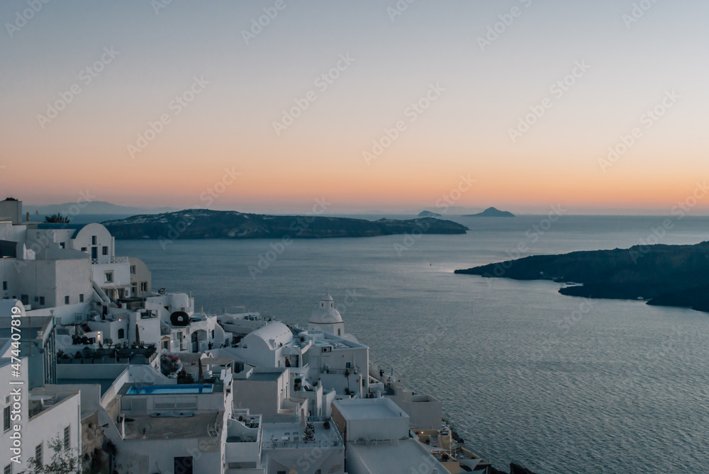 View of white walls of houses in Imerovigli at dusk after sunset View of white walls of houses in Imerovigli at dusk after sunset