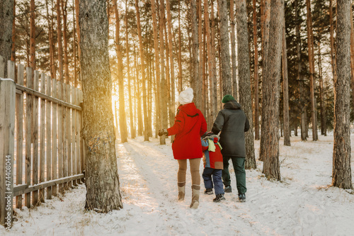 family walking in the winter forest