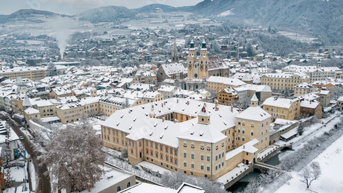 Episcopal Palace, Brixen Hofburg (Palazzo Vescovile) with Cathedral Santa Maria Assunta and San Cassiano in Bressanone, Brixen, Italy. Aerial view of the old center city covered with snow in winter