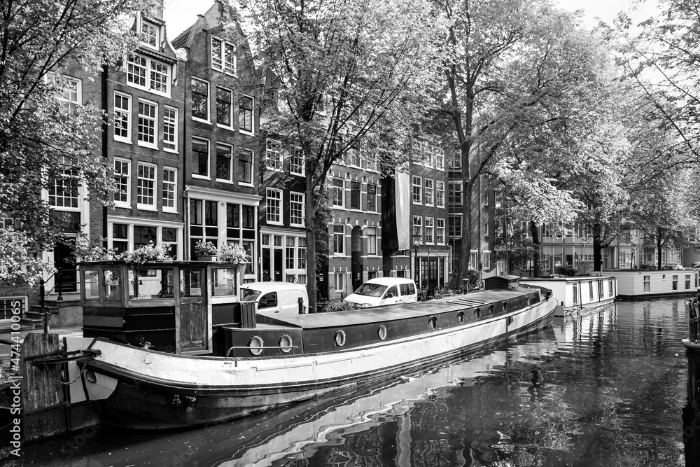 Fototapeta premium Canal in Amsterdam with houseboats