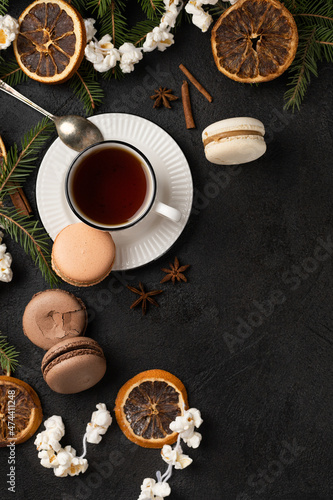 Tea cup with macarons in Christmas decorations