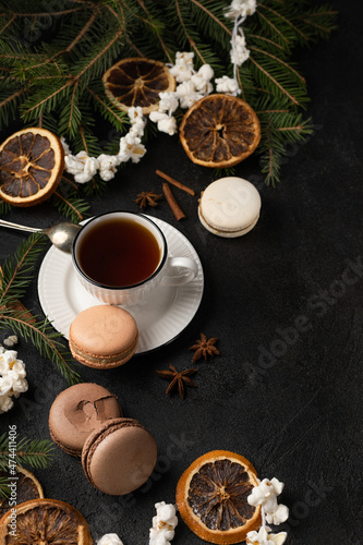 Tea cup with macarons in Christmas decorations