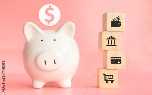 saving money, Real estate and financial concept bank, Image piggy bank saving money with white color piggy put on wooden table nature green background.