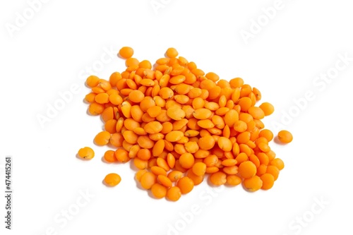 Top view red lentil grains isolated on white background.