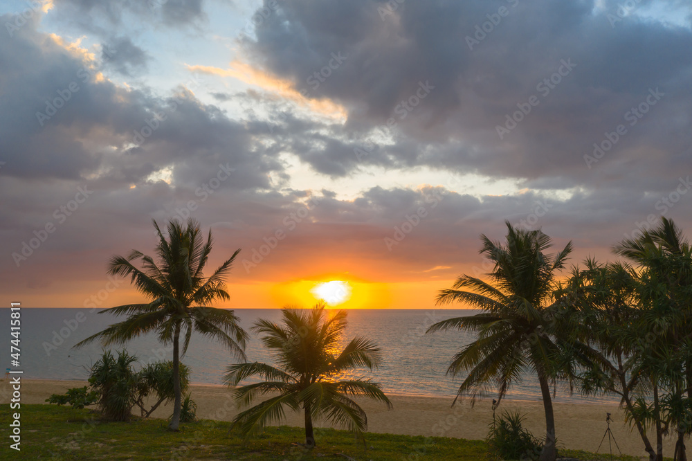 aerial view scenery sunset above coconut trees during colorful .cloud in sunset on Karon beach Phuket Thailand. Scene of Colorful light in the sky background.