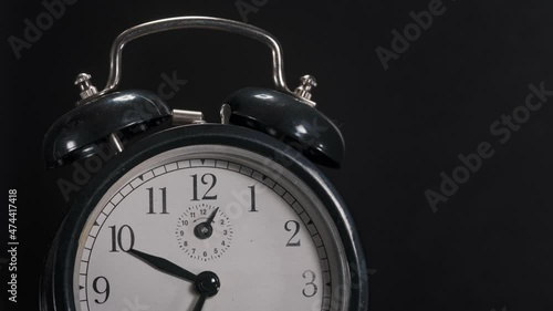 Alarm clock (retro, used) with fast running indicators, stopping at 5 to 12 for topics like climate change, deadlines, danger ... copy space for titles and informations.