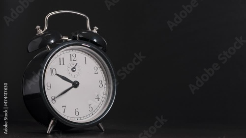 Alarm clock (retro, used) with fast running indicators, stopping at 5 to 12 for topics like climate change, deadlines, danger ... copy space for titles and informations.