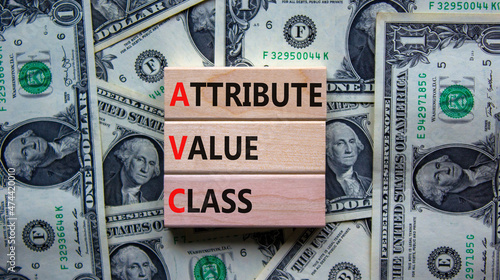 AVC attribute value class symbol. Concept words AVC attribute value class on wooden blocks. Beautiful background from dollar bills, copy space. Business and AVC attribute value class concept.