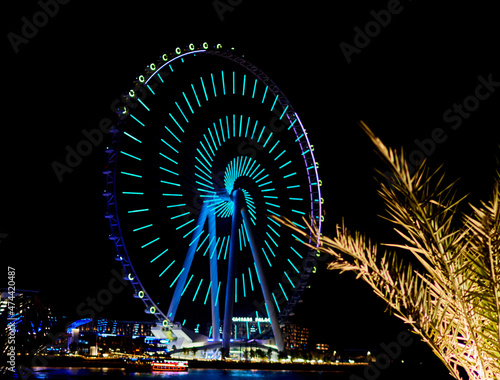 Ferris wheel in Dubai on a background of blue sky