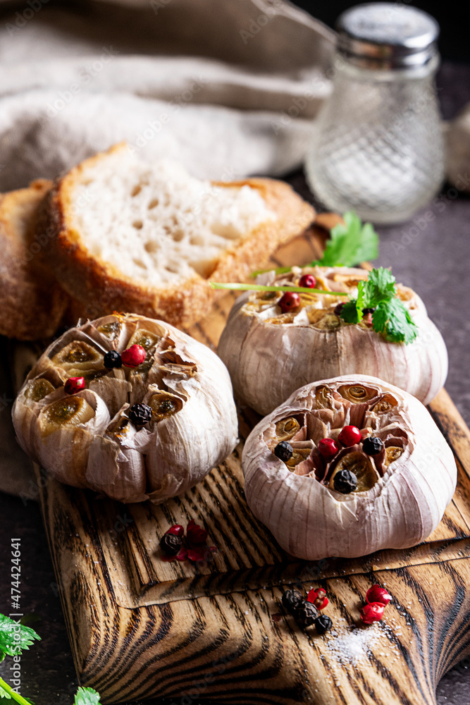 Roasted garlic on a wooden cutboard Roasted garlic on a wooden cutboard