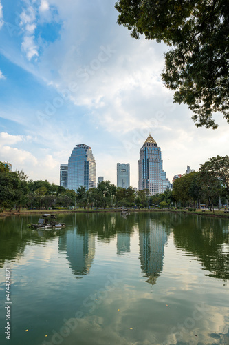 Lumpini park in Bangkok and the skyline of downtown Bangkok central area.  Lumphini park is a popular park public space for local residents and tourists.