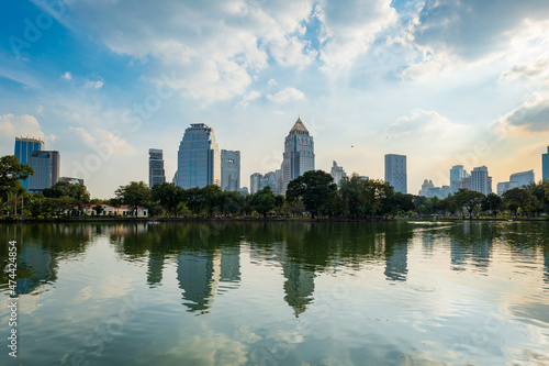 Lumpini park in Bangkok and the skyline of downtown Bangkok central area.  Lumphini park is a popular park public space for local residents and tourists.