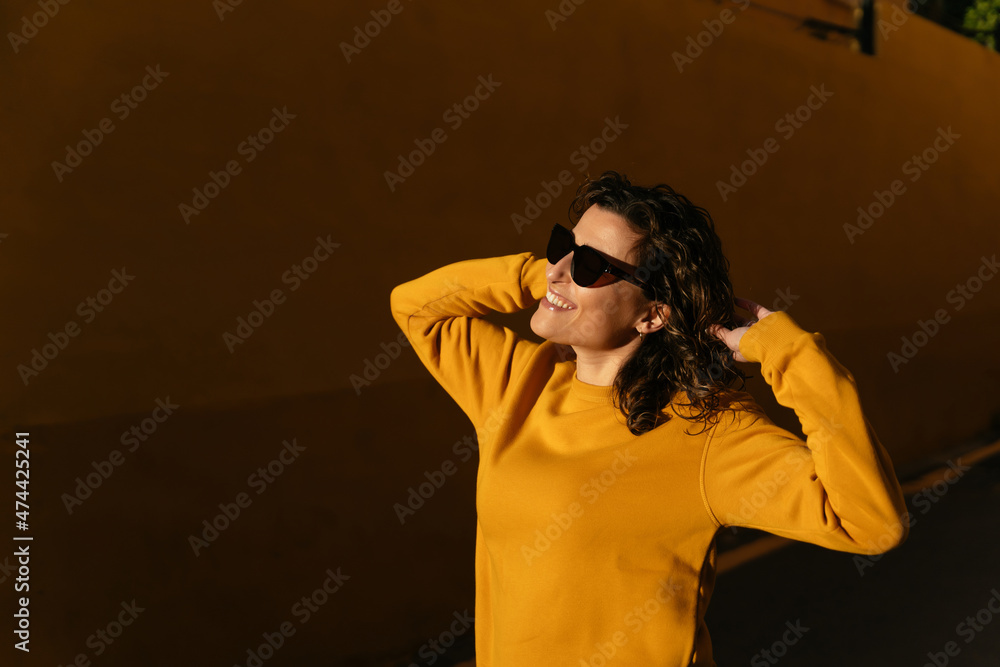 Young woman in sunglasses and sweater Young woman in sunglasses and sweater