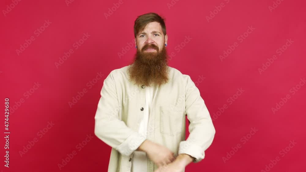 Redhead man with long beard keeping the arms crossed in confident expression over isolated background Redhead man with long beard keeping the arms crossed in confident expression over isolated background