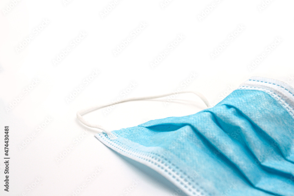 Disposed face mask over white background covid 19 pandemic waste Disposed face mask over white background covid 19 pandemic waste