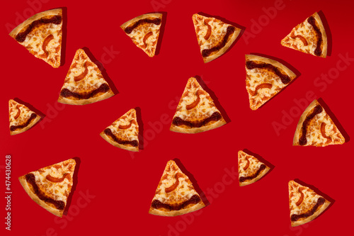Italian pizza Margarita, cut into slices on a red background. Close-up. Patern. Top view.