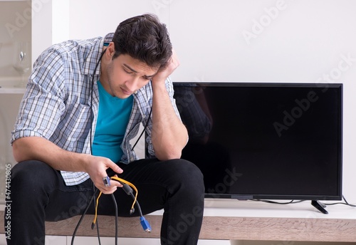 Man trying to fix broken tv photo