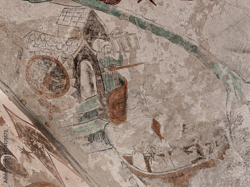 Lady sits in a mill depicting the legend of Saint Christophorus wading across the river photo