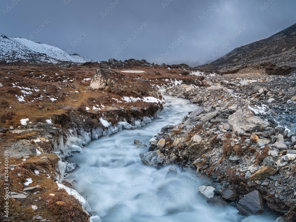 view to silver mountain river in long exposure and blurred flow in Nepal