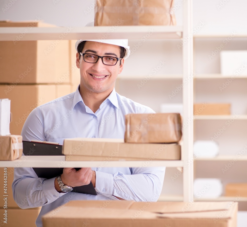 Man working in postal parcel delivery service office Man working in postal parcel delivery service office