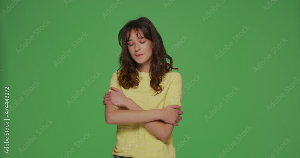 Self love. Beautiful young girl embracing herself smiling with pleasure, self-acceptance and self-confidence concept Self love. Beautiful young girl embracing herself smiling with pleasure, self-acceptance and self-confidence concept