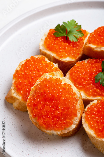 Sandwich with red caviar and butter close-up