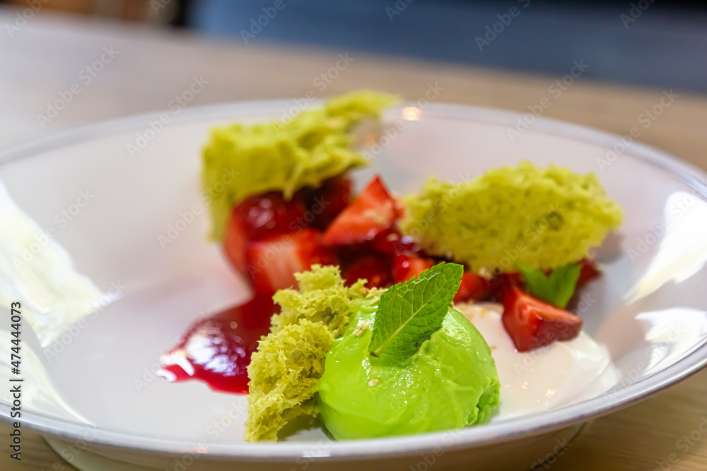 Dessert with sponge cake and strawberries is on the plate. Dessert with sponge cake and strawberries is on the plate.