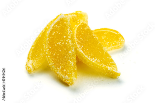Yellow jelly sugar marmalade candies in the form of lemon slices isolated on white background.