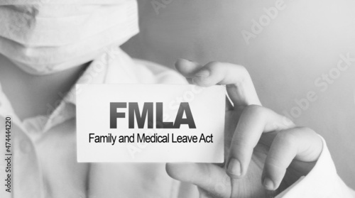 Doctor holding a card with text FMLA medical concept photo