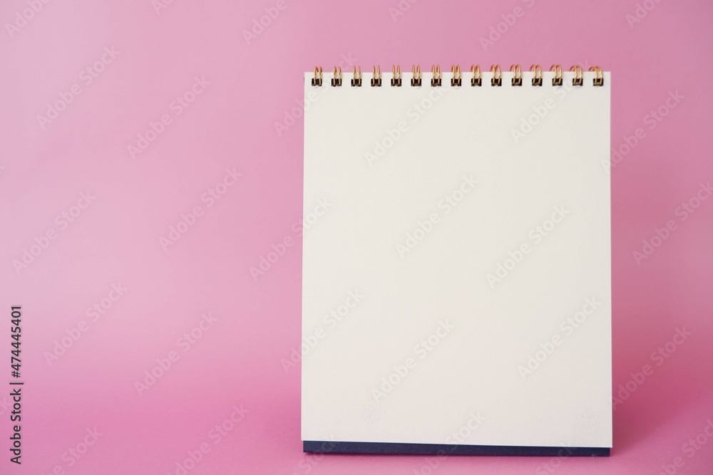 A paper white calendar stands on the table. Mock Up Vector Template. Blank Calendar on pink background. A paper white calendar stands on the table. Mock Up Vector Template. Blank Calendar on pink background.
