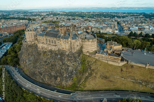 Aerial view of Edinburgh in Scotland, with the royal castle occupying a commanding position atop a volcanic crag with cliffs on three sides and the fourth side facing the capital city of Edinburgh