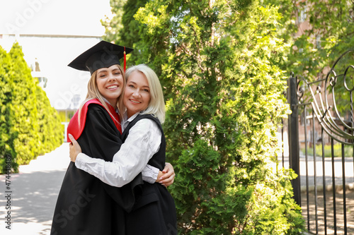 Happy young woman with her mother on graduation day