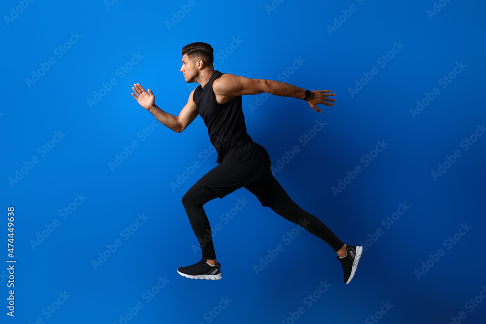 Fototapeta premium Sporty male runner on color background