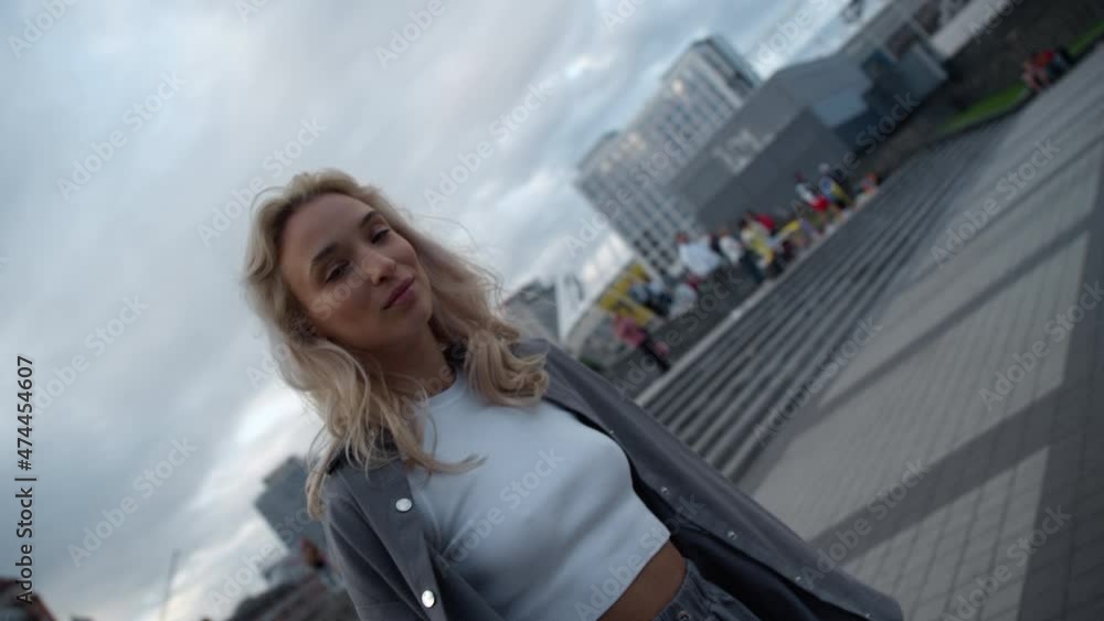 Smiling woman standing downtown in modern city buildings area. Smiling woman standing downtown in modern city buildings area.